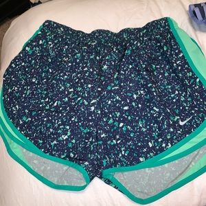 navy blue nike shorts with white and green dots
